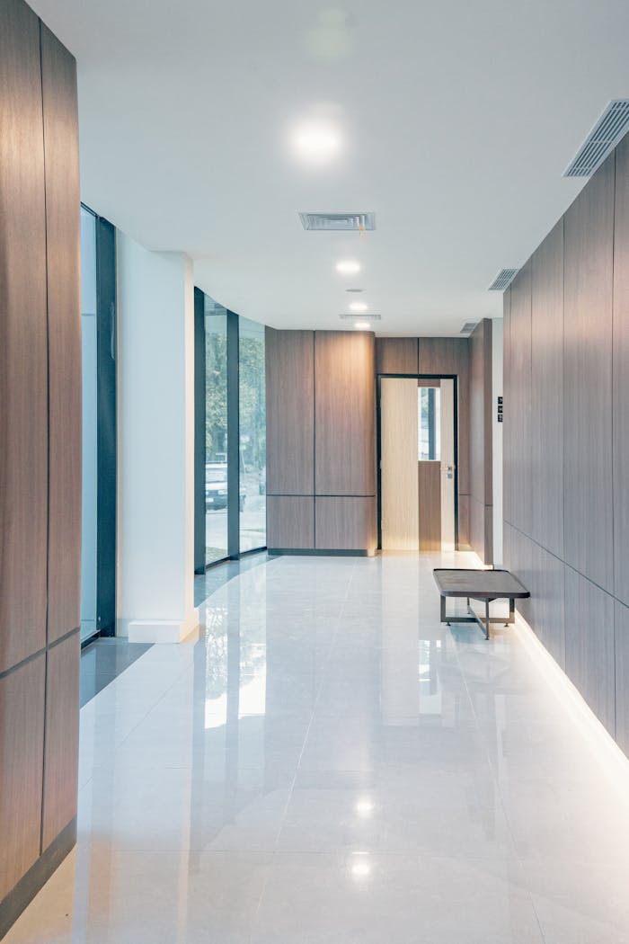 Bright, minimalist lobby interior with wooden paneling and sleek modern design.